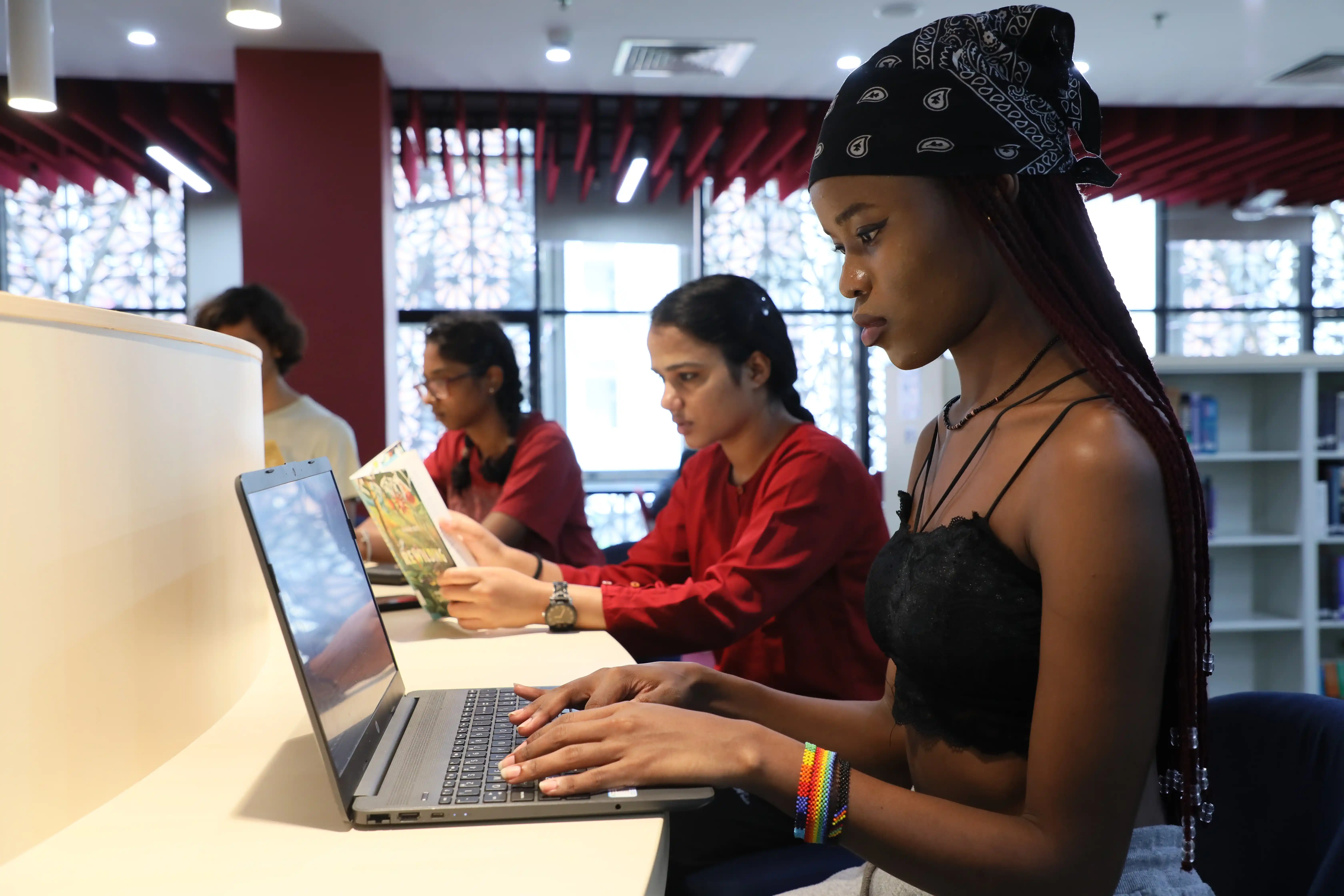 Students collaborating on a laptop in a computer science learning environment